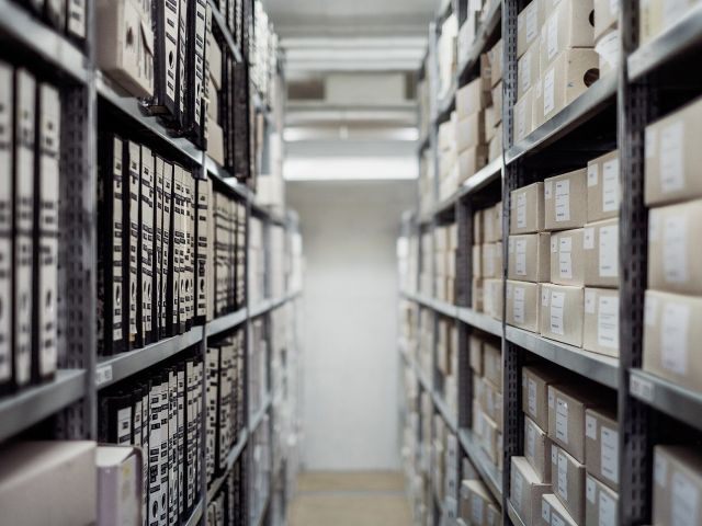 Archive shelves Archive shelves lined with document boxes and files