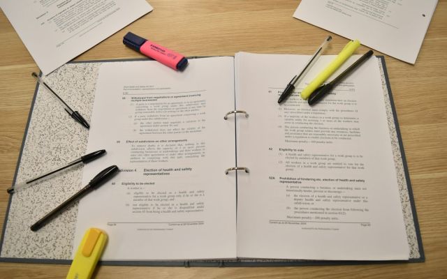 Binder highlighters Open ring binder of legislation with pens and highlighters