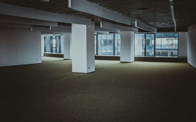 Vacant office floor Vacant office floor with bare carpet and city windows